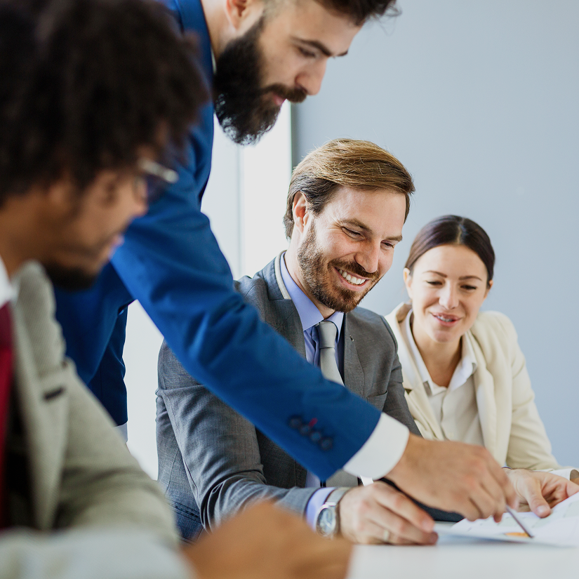 Team members discussing business strategies in a modern conference room meeting