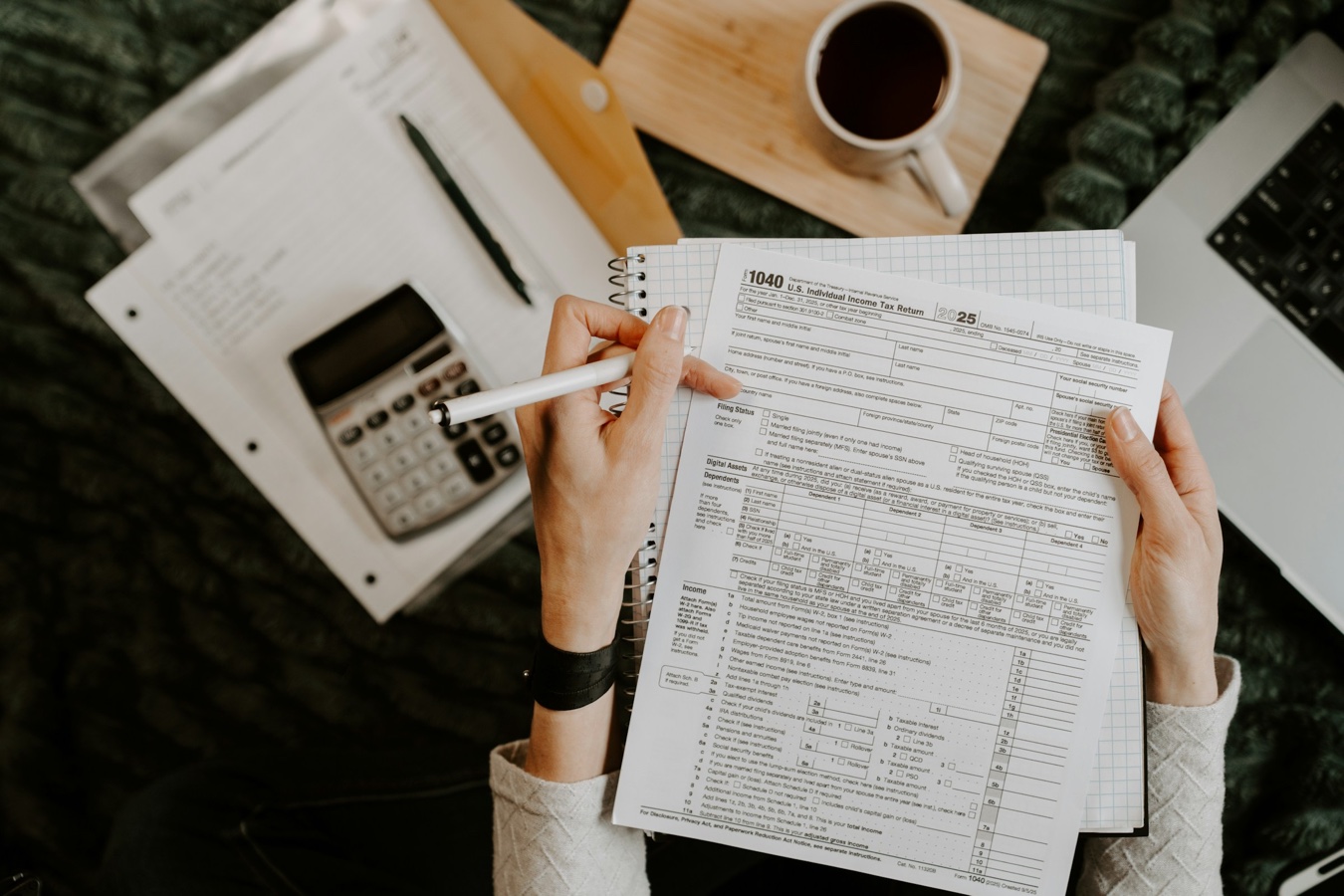 Person reviewing financial documents at home